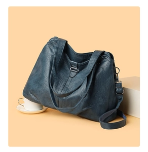 Detail view of navy blue vintage hobo tote bag with soft leather texture and metal buckle