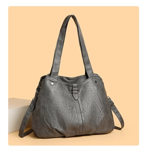 Close-up of grey large tote bag with soft pleated texture and metal buckle details