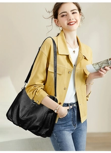 Detail of a black ruched leather tote bag showing soft texture and large capacity