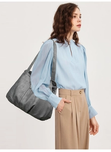 Detail of dark grey tote bag with soft wrinkled leather texture and wide shoulder strap