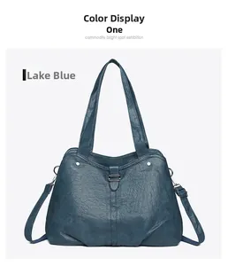 Detail of lake blue leather tote bag with wrinkled texture, handles, and metal hardware