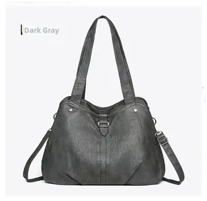 Close-up of dark grey textured tote bag with silver metal studs and detachable strap