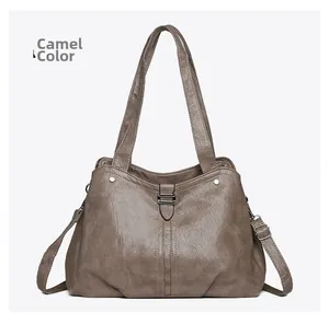 Detail view of camel tote bag with soft leather texture and adjustable shoulder strap