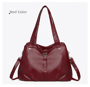 Deep red tote bag detail showing wrinkled faux leather texture and silver hardware