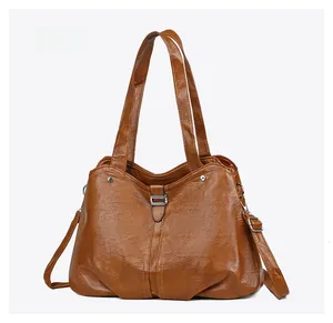 Detail of caramel brown faux leather tote with lychee texture and silver buckle
