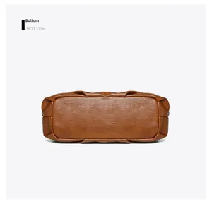 Detail view of the flat bottom structure and smooth edges on a brown leather tote bag