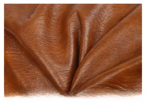 Close-up of deep brown textured leather tote showing soft grain and natural oil finish