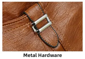 Detail of silver metal buckle and lychee grain leather texture on brown tote bag