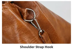 Macro view of silver strap hook and fine lychee grain leather texture on brown tote bag