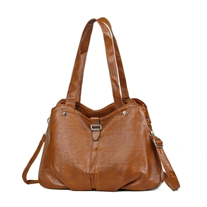 Minimalist brown faux leather tote bag with top handles and adjustable shoulder strap