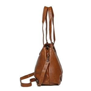 Brown faux leather tote bag with long handles and adjustable crossbody strap shown from side