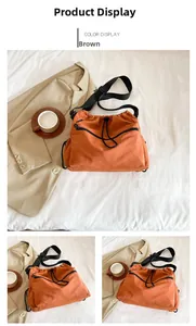 Detail view of orange-brown nylon drawstring bucket bag with black adjustable strap