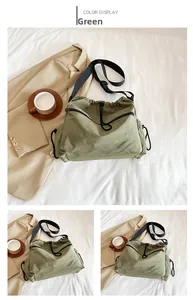 Detailed view of green nylon bucket bag featuring drawstring and front zipper pockets