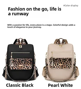 Detail view of large leopard print splicing backpacks in black and pearl white colors