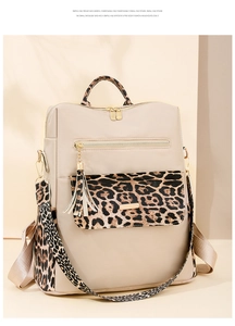 Detail view of leopard print trim on waterproof nylon backpack with golden zipper