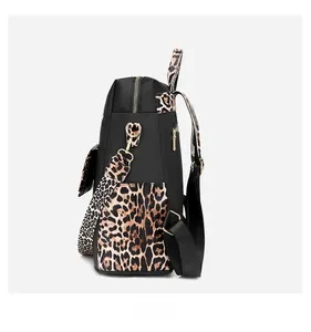 Side view of anti-theft nylon backpack featuring leopard print details and gold zippers
