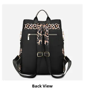 Back view of leopard print trim nylon backpack showing anti-theft zipper pocket and gold hardware