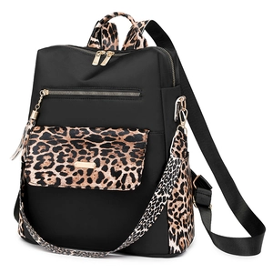 Large black nylon backpack with leopard print trim and gold hardware in a 45-degree view