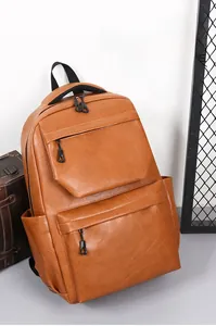 Brown PU leather travel backpack featuring dual zipper front pockets and a sturdy handle