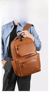 Detail of caramel brown PU leather backpack featuring three zipper pockets and thick straps