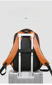 Brown PU leather travel backpack featuring a breathable mesh back and luggage trolley strap