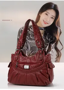 Detail of dark red faux leather texture and elegant woven trim on the shoulder bag