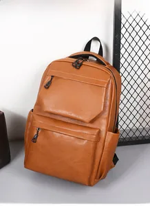 Detail shot of brown PU leather travel backpack with multiple zippers and clear texture