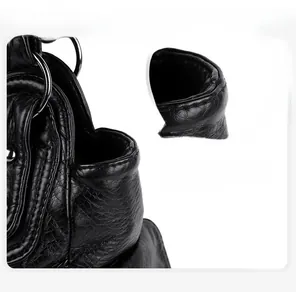 Detail of silver metallic ring and reinforced stitching on black washed leather bag