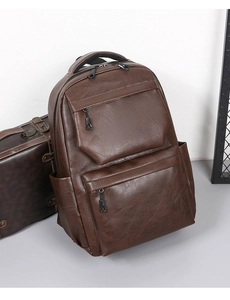 Detailed view of dark brown PU leather travel backpack with textured surface and pockets