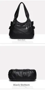 Detail view of the black soft leather bag back with zipper pocket and wide round base