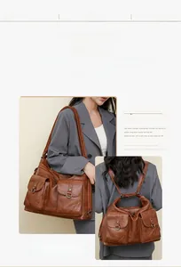 Brown vintage faux leather tote detail showing front snap pockets and d-ring hardware