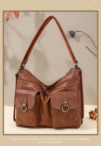 Close-up of brown vintage soft leather bag with magnetic flap pockets and metal rings
