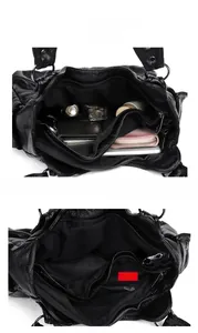 Detail of multi-compartment interior structure of black faux leather crossbody bag