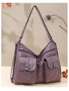 Close-up of purple retro soft leather tote with dual pockets and metal ring buckles