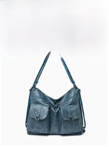 Detailed front view of gray-blue soft leather tote bag with multi-pocket design and zippers
