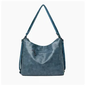 Detail view of the back of a vintage dark blue leather tote bag with a functional zipper pocket