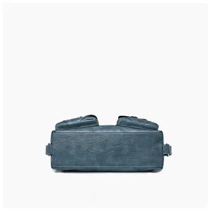 Detailed bottom view of blue vintage leather bag showing textured rectangular base