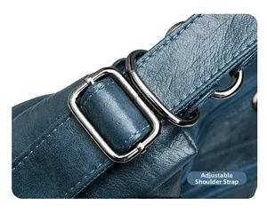Detail view of adjustable strap with polished silver buckle on navy blue leather tote