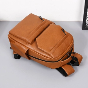 Brown PU leather travel backpack with lychee texture and multiple zipper pockets for men