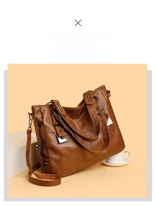 Macro shot of brown faux leather shoulder bag with silver hardware and vintage texture