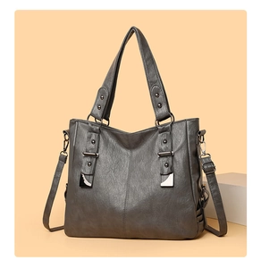 Detail view of large dark grey tote bag with soft leather texture and adjustable strap