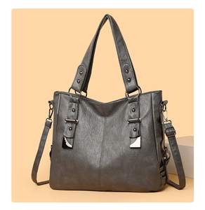 Detail view of vintage grey soft leather tote bag with metallic ring and strap accents