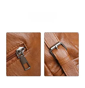 Close-up of litchi grain leather texture and metallic zipper detail on brown tote bag