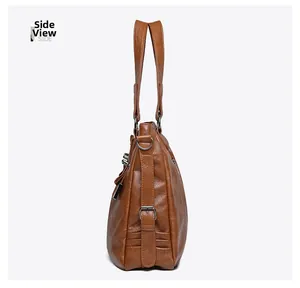 Side view of brown soft leather tote bag showing wax texture and metal ring detail