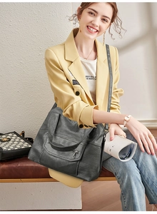 Detail of the multi-pocket large capacity leather tote bag with functional zippers