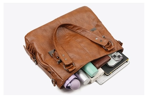 Spacious interior of dark brown soft leather tote bag showing high storage capacity