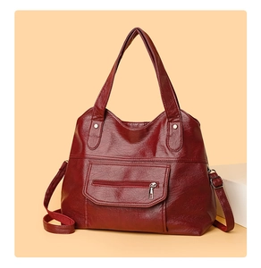 Detail view of wine red PU leather tote bag with silver studs and side zipper pocket
