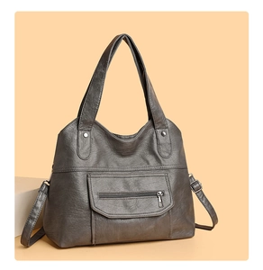 Detailed side view of dark grey PU leather tote bag with vintage texture and front pocket