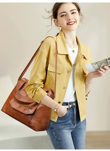 Retro brown PU leather tote bag with multi-zipper pockets worn by a model in soft light
