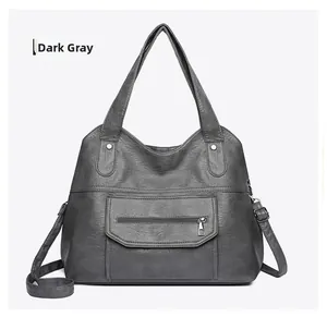 Detail view of dark grey PU leather tote bag with fine litchi texture and metal zipper